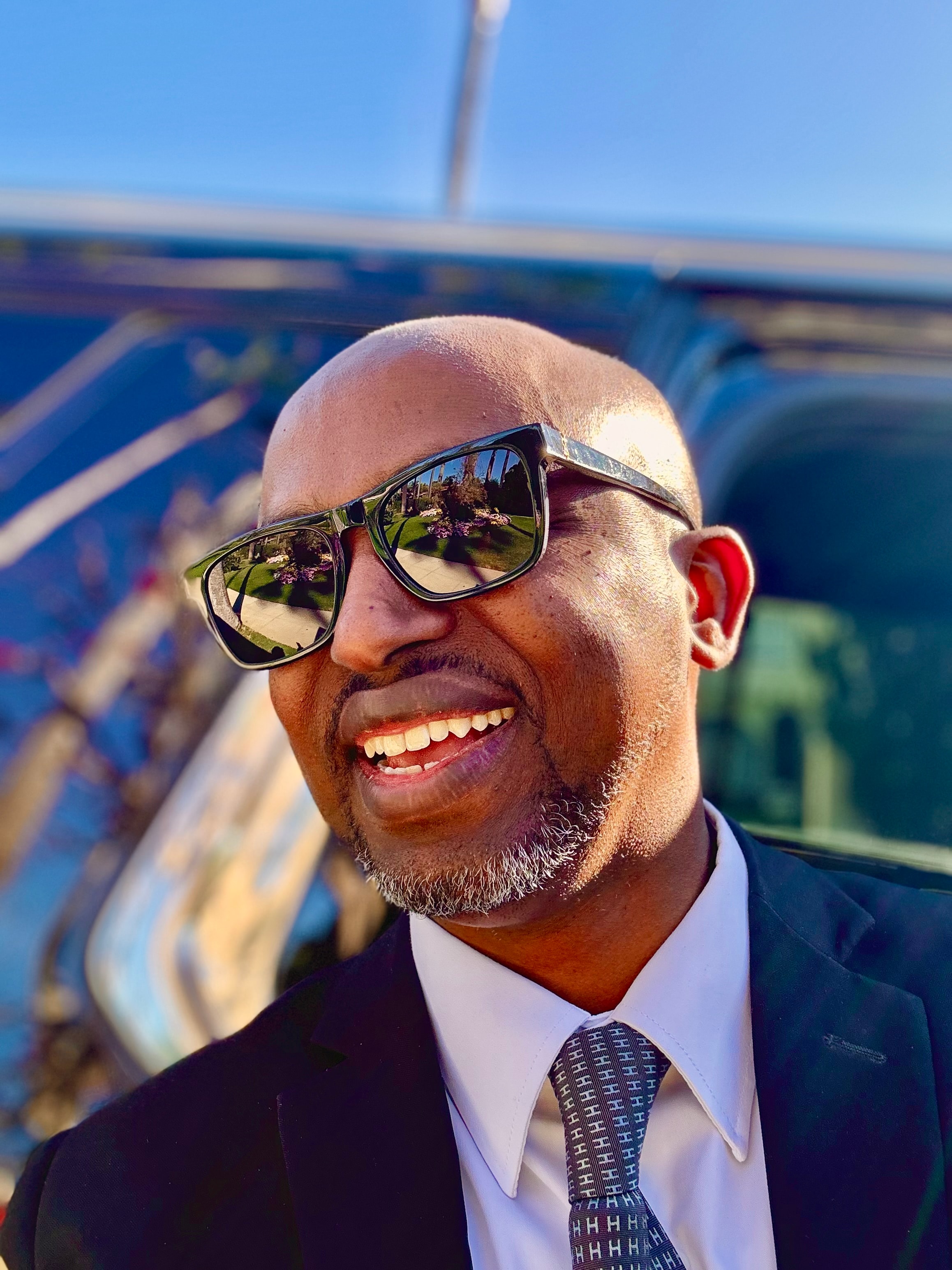 Business traveler opening a luxury vehicle door